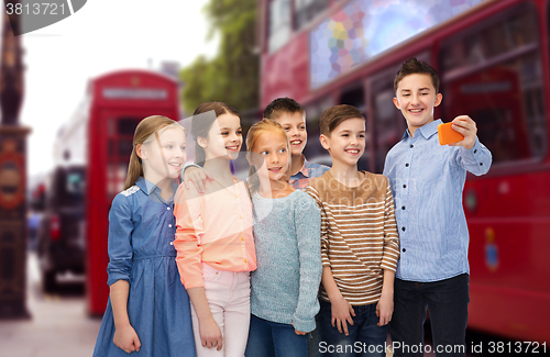 Image of kids talking selfie by smartphone over london city