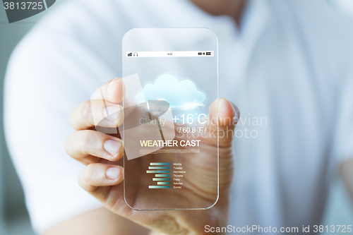 Image of close up of hand with weather cast on smartphone