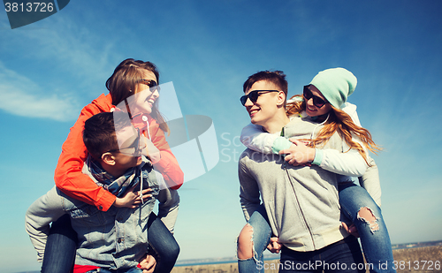 Image of happy friends in shades having fun outdoors