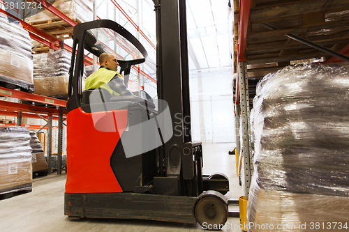 Image of man on forklift loading cargo at warehouse