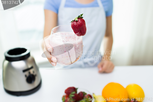 Image of close up of woman holding glass with fruit shake