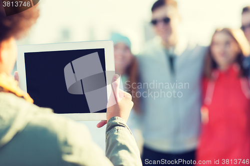 Image of close up of friends with tablet pc photographing