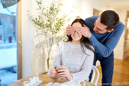 Image of happy couple drinking tea at cafe