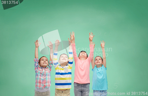 Image of happy children celebrating victory over green