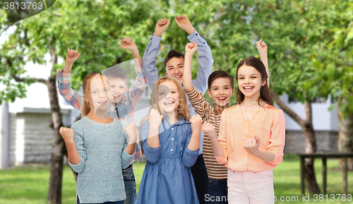 Image of happy children celebrating victory over backyard