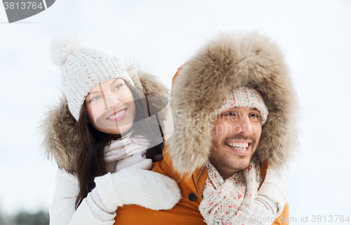 Image of happy couple having fun over winter background