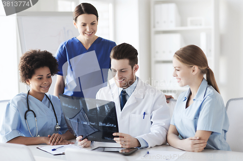 Image of group of happy doctors discussing x-ray image
