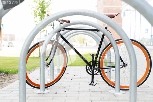 Image of close up of fixed gear bicycle at street parking