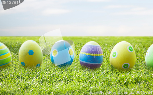 Image of close up of colored easter eggs on wooden surface