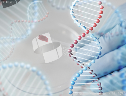 Image of close up of scientist with blood sample in lab