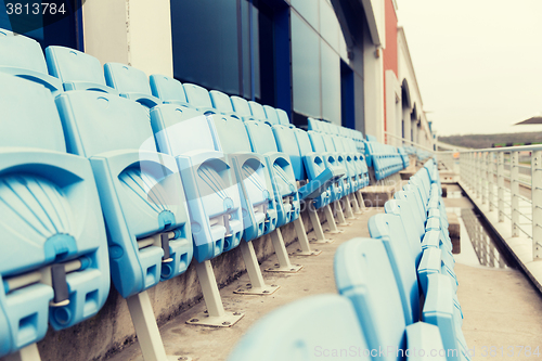 Image of rows with folded seats of bleachers on stadium