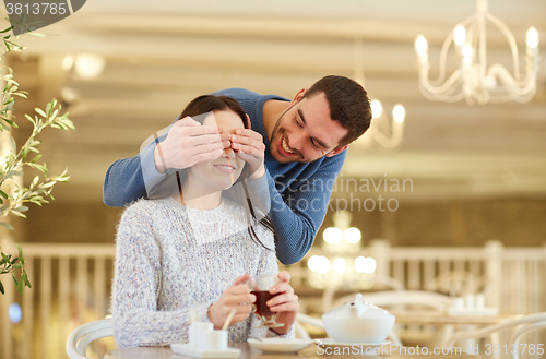 Image of happy couple drinking tea at cafe