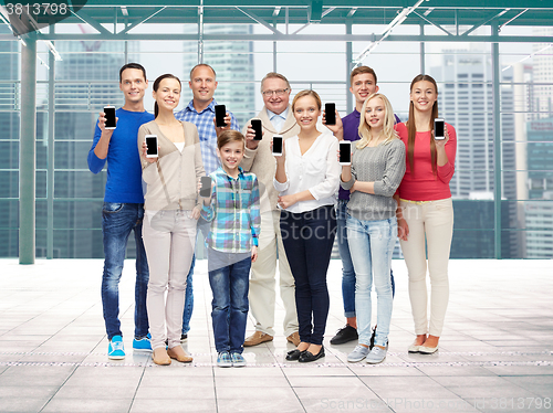 Image of group of smiling people with smartphones