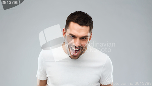 Image of angry man over gray background