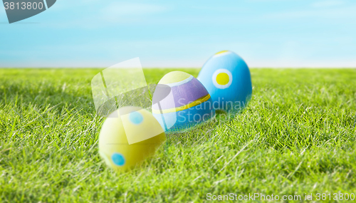 Image of close up of colored easter eggs on grass