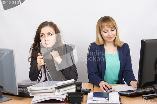 Image of Female colleagues in the office, one hates to work, like a second job