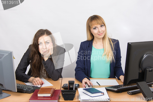 Image of Two girls looking to frame a joy, and the second upset