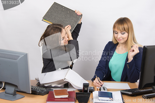 Image of Girl in office with folder anger trying to hit his colleague