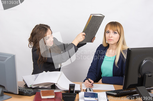 Image of The girl in the office has a head of his colleague big folder