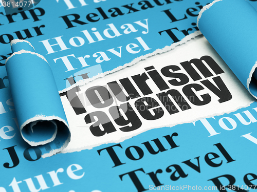 Image of Travel concept: black text Tourism Agency under the piece of  torn paper