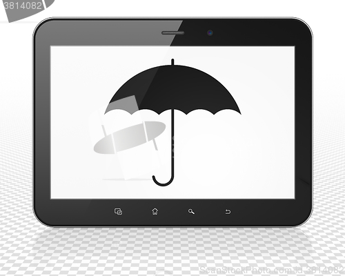 Image of Protection concept: Tablet Pc Computer with Umbrella on display