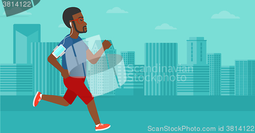 Image of Man jogging with earphones and smartphone.