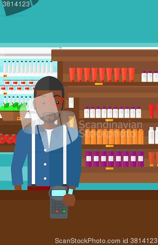 Image of Man paying with smart watch.
