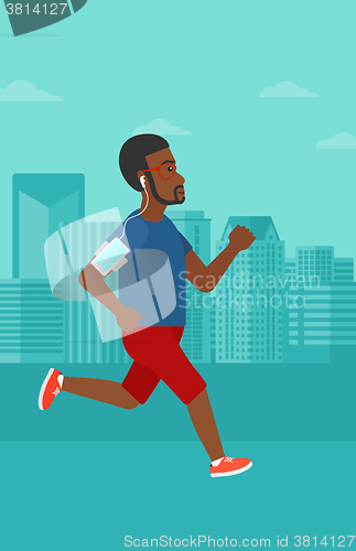 Image of Man jogging with earphones and smartphone.