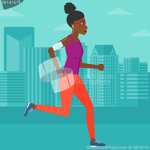 Image of Woman jogging with earphones and smartphone.