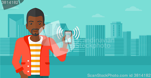 Image of Man holding ringing telephone.