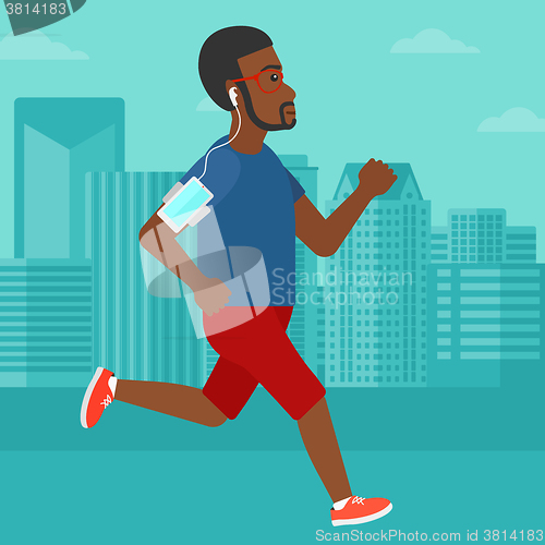 Image of Man jogging with earphones and smartphone.