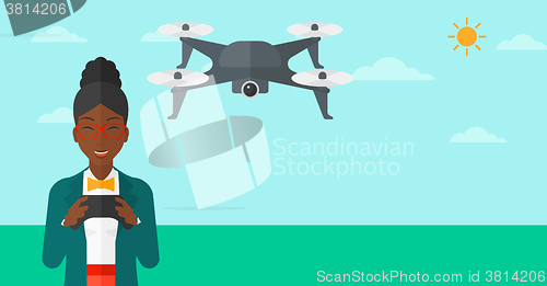 Image of Woman flying drone.