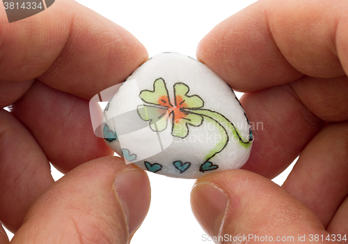 Image of Stone with drawing of a clover four and small hearts