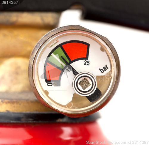 Image of Dusty fire extinguisher fully charged, selective focus