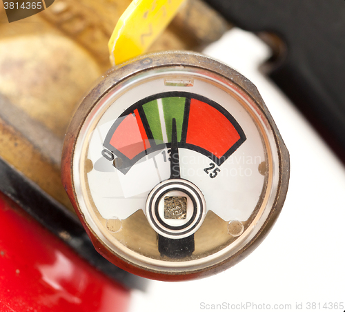 Image of Dusty fire extinguisher fully charged, selective focus