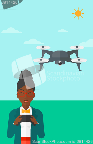 Image of Woman flying drone.
