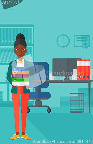 Image of Woman holding pile of folders.