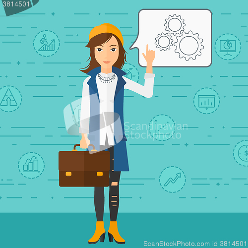 Image of Business woman pointing at cogwheels.