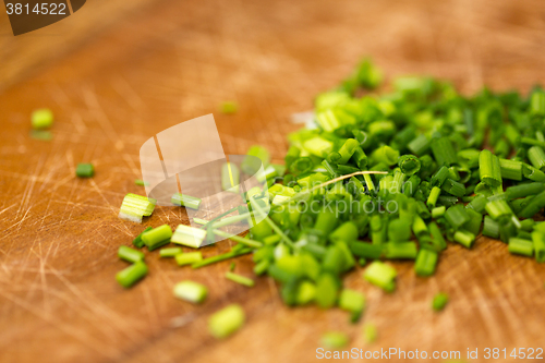 Image of close up of chopped onion on wooden cutting board