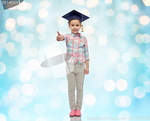 Image of happy girl in bachelor hat showing thumbs up