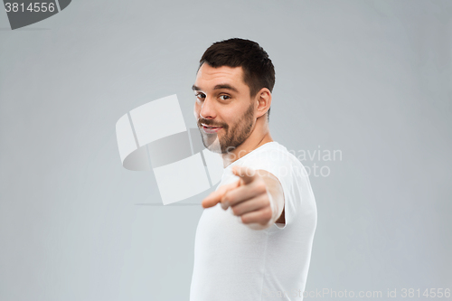 Image of man pointing finger to you over gray background