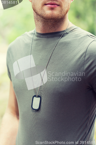 Image of close up of young soldier in military uniform