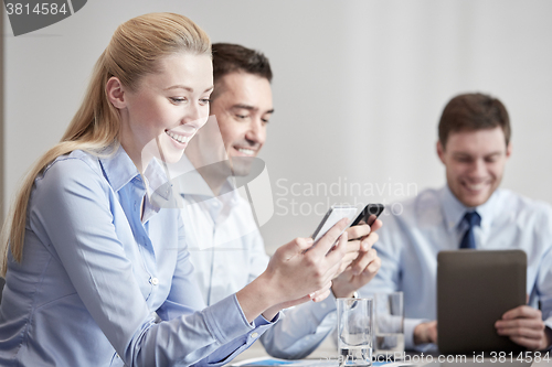 Image of businesspeople with smartphones and tablet pc