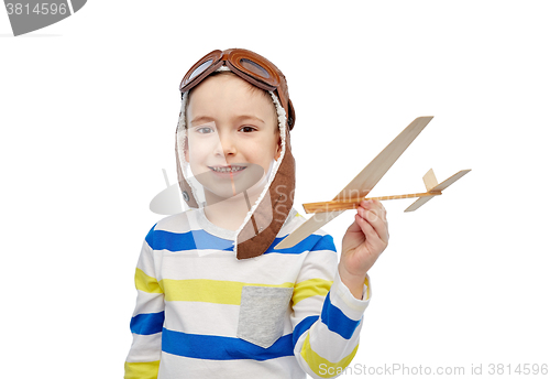 Image of happy little boy in aviator hat with airplane