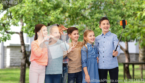 Image of happy children with smartphone and selfie stick