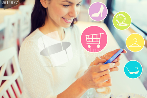 Image of smiling woman with smartphone shopping online