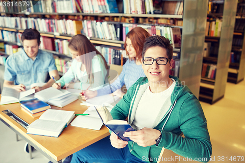 Image of students with books preparing to exam in library