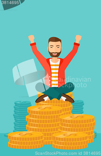 Image of  Happy businessman sitting on coins.