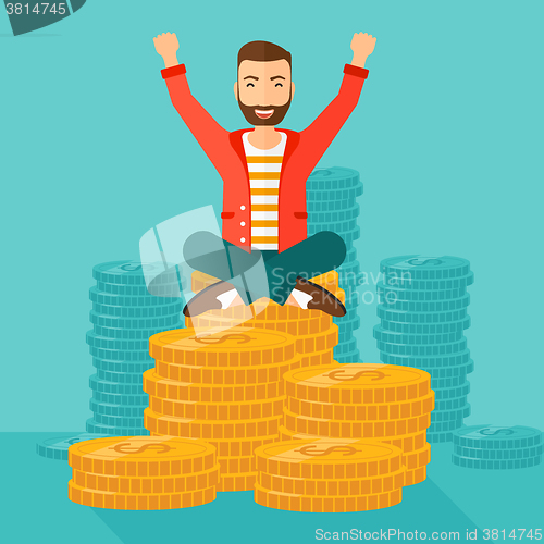 Image of  Happy businessman sitting on coins.