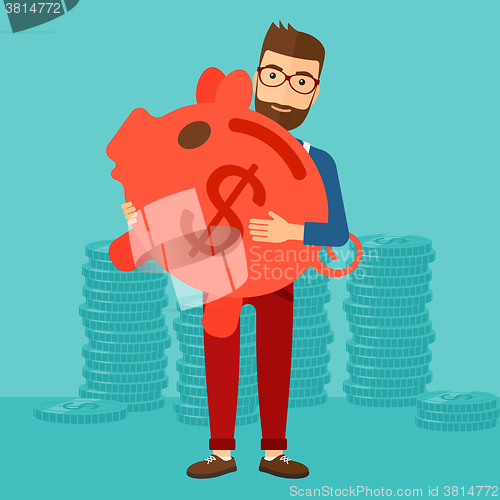 Image of Man carrying piggy bank.
